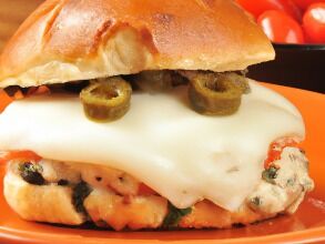 Turkey burgers with roasted tomatoes, gooey mozzarella, and basil.